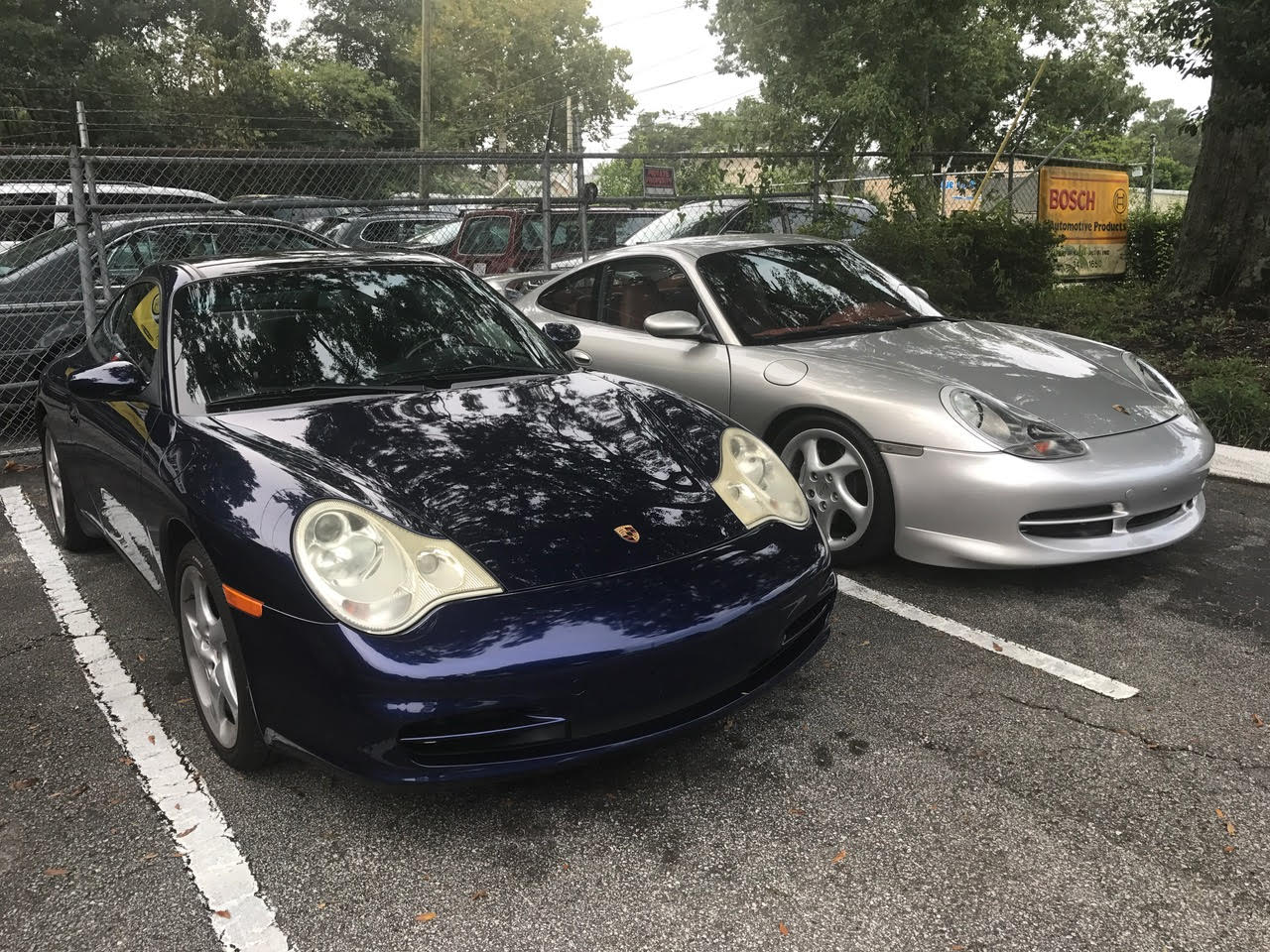 Navy Car and Silver Car in Parking Spot